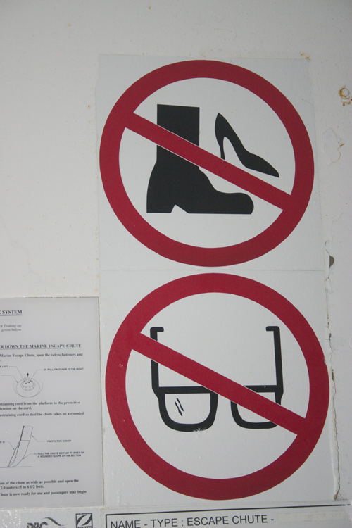 [ A sign showing heels and boots under a crossed circle, and glasses under a crossed circle ]