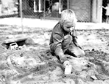 [ Picture of me, age 7, in a sandbox playing ]